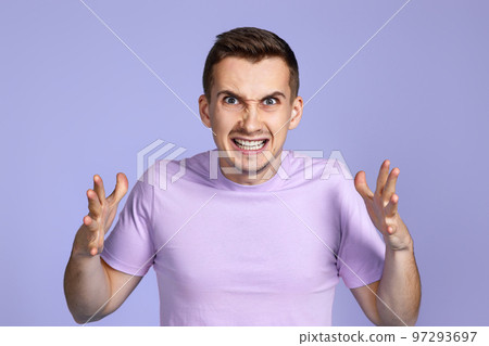 annoyed angry man on pastel purple studio background 97293697