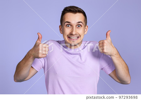 positive man showing thumbs up and looking at camera 97293698