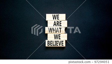 We are what we believe symbol. Concept words We are what we believe on wooden blocks. Beautiful black table black background. Business, motivational we are what we believe concept. Copy space. 97294051