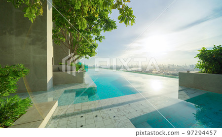 Swimming pool on rooftop of hotel apartment building in Bangkok downtown skyline, urban city view. Relaxing in summer season in travel holiday vacation concept. Recreation lifestyle. Swimming pool on rooftop of hotel apartment building in Bangkok downtown skyline, urban city view. Relaxing in summer season in travel holiday vacation concept. Recreation lifestyle. 97294457