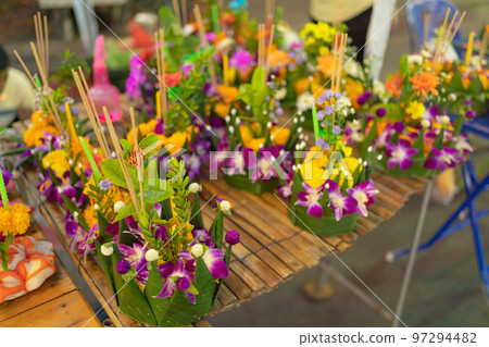 Loy Krathong in Thailand , floating on water in local street market festival. Celebration and Culture. People holiday at night. Thai event. it made by banana leaf. 97294482