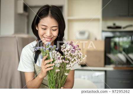 Weekend with her hobbies, Asian woman arranges a bouquet of flowers to decorate her home and beautify, Artificial flower arrangement, living room decoration ideas, Flowers bunch, Arts and crafts 97295262