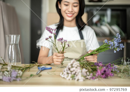 Weekend with her hobbies, Asian woman arranges a bouquet of flowers to decorate her home and beautify, Artificial flower arrangement, living room decoration ideas, Flowers bunch, Arts and crafts Weekend with her hobbies, Asian woman arranges a bouquet of flowers to decorate her home and beautify, Artificial flower arrangement, living room decoration ideas, Flowers bunch, Arts and crafts 97295769