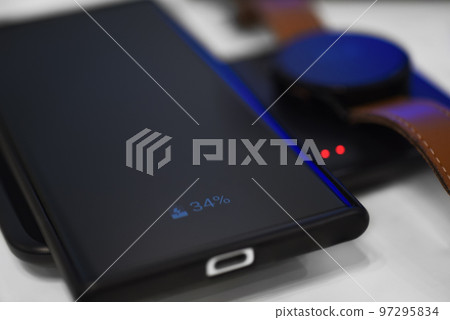 Smartphone and watch charging on wireless charger 97295834