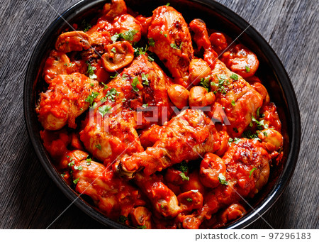 chicken stew with mushrooms in a tomato sauce 97296183