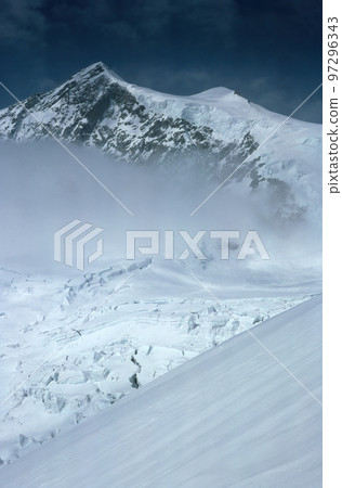 Panorama of snowy mountains and high alpine peaks in wintery Bernese Oberland in Switzerland Panorama of snowy mountains and high alpine peaks in wintery Bernese Oberland in Switzerland 97296343