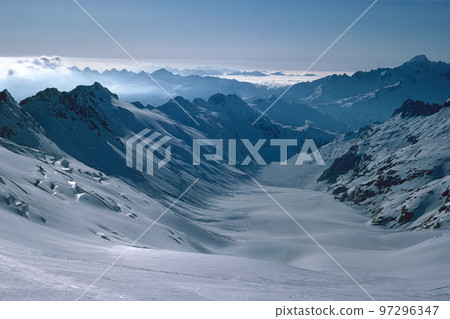 Panorama of snowy mountains and high alpine peaks in wintery Bernese Oberland in Switzerland Panorama of snowy mountains and high alpine peaks in wintery Bernese Oberland in Switzerland 97296347