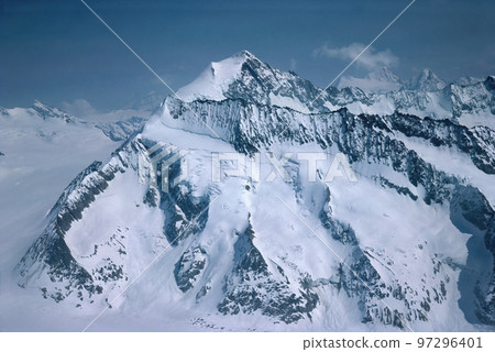Panorama of snowy mountains and high alpine peaks in wintery Bernese Oberland in Switzerland 97296401