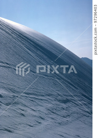 Panorama of snowy mountains and high alpine peaks in wintery Bernese Oberland in Switzerland 97296403