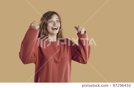Portrait of happy excited surprised amazed young woman smiling and celebrating success Portrait of happy excited surprised amazed young woman smiling and celebrating success 97296450