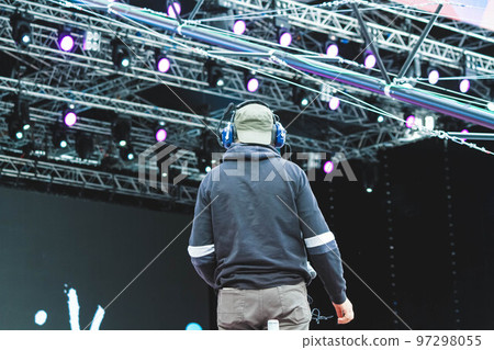 The operator with a video camera shoots a concert. Shooting video at the event. 97298055