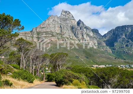 Below view of a mountain peak in South Africa against a cloudy blue sky with copy space. Scenic nature landscape of a remote hiking and travel destination to explore near Table Mountain in Cape Town Below view of a mountain peak in South Africa against a cloudy blue sky with copy space. Scenic nature landscape of a remote hiking and travel destination to explore near Table Mountain in Cape Town 97299708