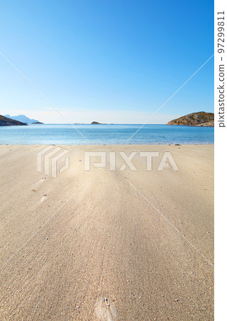 A relaxing beach on a summer day ideal for vacation. Calm, blue ocean, beige sands with islands in the background..An isolated coast in the city of Bodoe, north of the Polar Circle 97299811