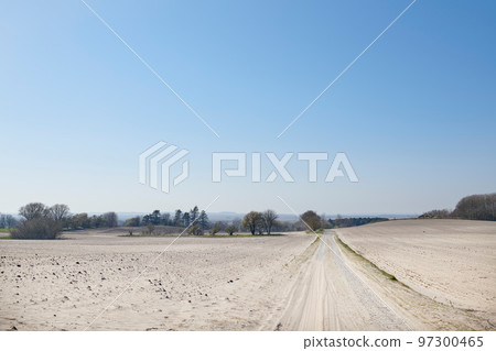 A sandy countryside road with blue sky copy space. Nature landscape of a dry farm land with an open dirt road and trees growing in a sustainable eco environment on a sunny day A sandy countryside road with blue sky copy space. Nature landscape of a dry farm land with an open dirt road and trees growing in a sustainable eco environment on a sunny day 97300465