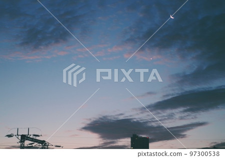 Crescent moon in the dawn sky 97300538