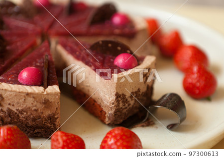 chocolate cake with strawberries close up. slice with chocolate drips and souffle. Confectionery chocolate cake with strawberries close up. slice with chocolate drips and souffle. Confectionery 97300613