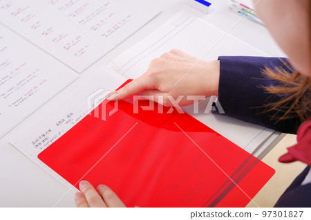 A girl who memorizes the answer with a red underlay A girl who memorizes the answer with a red underlay 97301827