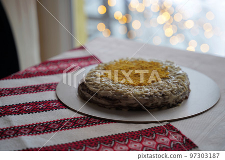 Homemade layered liver cake. Traditional Ukrainian food on the table with embroidered tablecloth. Homemade layered liver cake. Traditional Ukrainian food on the table with embroidered tablecloth. 97303187
