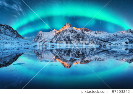 Northern lights over the mountain, sea coast, reflection in water 97303243
