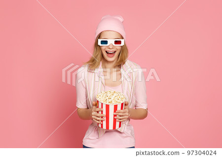 pretty blonde girl holding bucket of popcorn pretty blonde girl holding bucket of popcorn 97304024