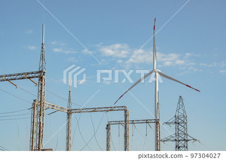 Windmill supports functioning of substation against sky Windmill supports functioning of substation against sky 97304027