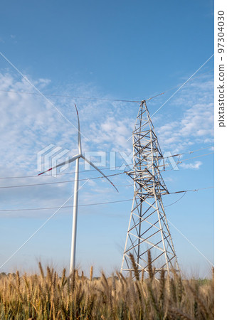 Windmill generates energy for power transmission lines Windmill generates energy for power transmission lines 97304030