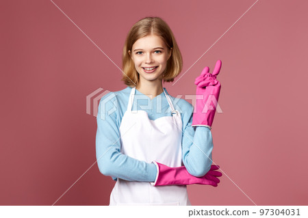 woman in apron holding index finger up with new idea woman in apron holding index finger up with new idea 97304031