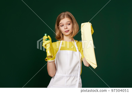 frowning woman cleaner apron with cleaning rag and detergent sprayer frowning woman cleaner apron with cleaning rag and detergent sprayer 97304051