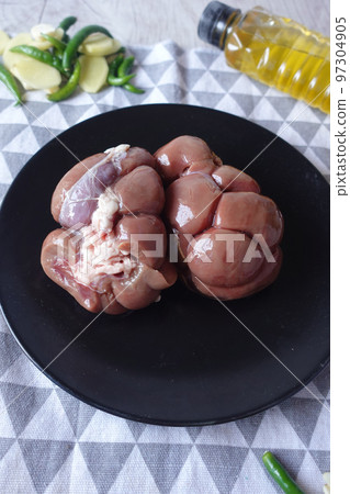 Raw fresh lamb kidneys on a chopping board Raw fresh lamb kidneys on a chopping board 97304905