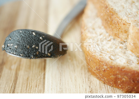 Black sesame spread on a bread Black sesame spread on a bread 97305034