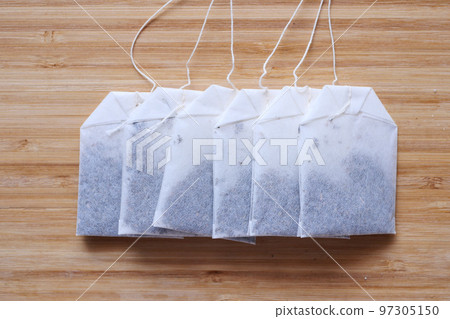 tea bags and yellow color mug on table  tea bags and yellow color mug on table  97305150