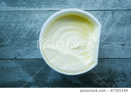 fresh butter in a container with bread on white background fresh butter in a container with bread on white background 97305194