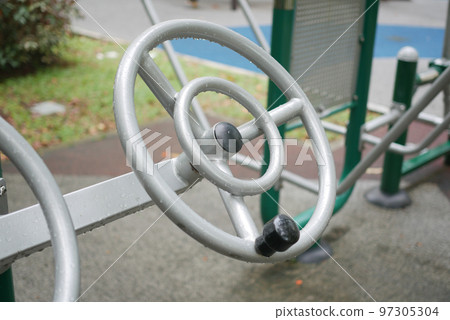 Outdoor fitness machines in a park in singapore  97305304