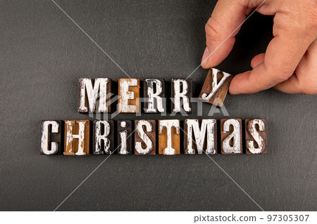 Merry Christmas concept. Greeting on a dark chalkboard background 97305307