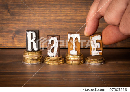 RATE Concept. Text and money on dark wood texture background 97305318