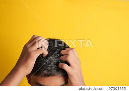 teenage boy Scratching Head Against black background . teenage boy Scratching Head Against black background . 97305355
