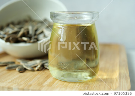 sunflower oil seed and oil in a container on table sunflower oil seed and oil in a container on table 97305356