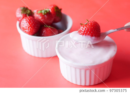 Yogurt and strawberry in a bowl on white  97305375