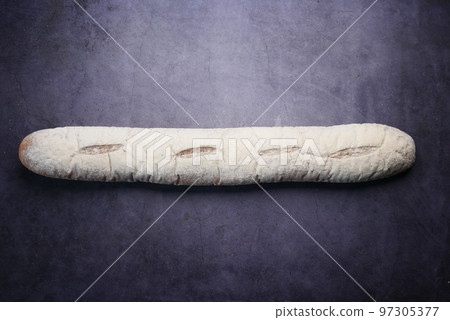 freshly baked baguette on black background, top view freshly baked baguette on black background, top view 97305377