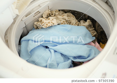 close up of cloths in a washing machine. 97305390