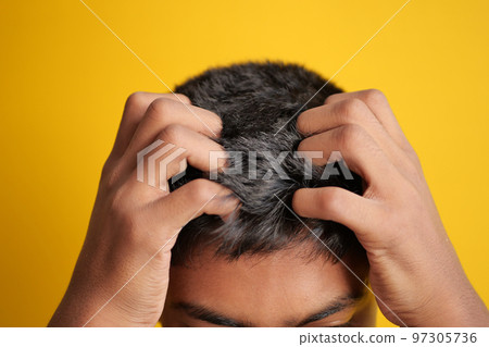 teenage boy Scratching Head Against black background . 97305736