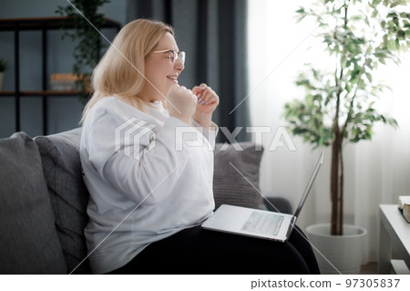 Woman with good news on laptop Woman with good news on laptop 97305837