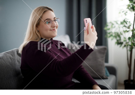 Woman having video call on mobile 97305838