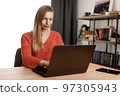 Woman using laptop at home 97305943