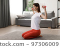 Woman training with dumbbells 97306009