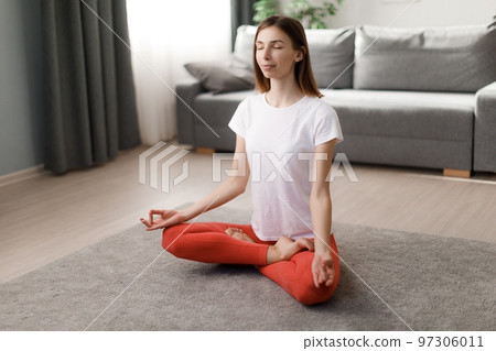 Woman meditating at home Woman meditating at home 97306011