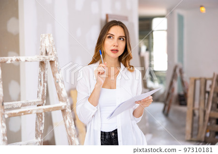 Woman construction manager checking project documentation 97310181
