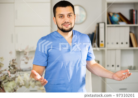 Portrait of positive man physician explaining with gestures 97310201