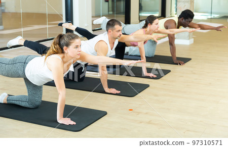 Sporty people practicing pilates at group class 97310571