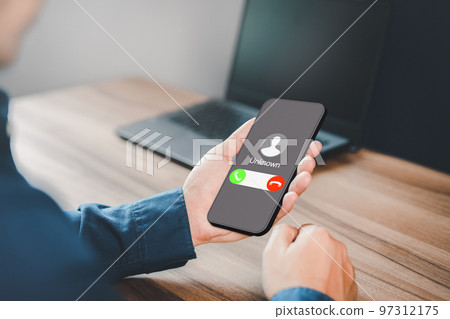 Man answering to incoming call. Phone call from unknown number. Call center gang, scammer or stranger. Hoax person with fake identity. Scam, fraud or phishing with mobile phone or smartphone concept. 97312175